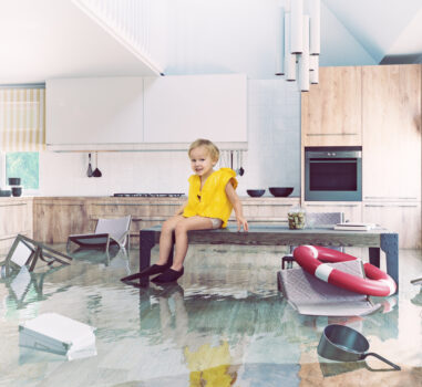 Boy playing On Table While Flooding in the kitchen.